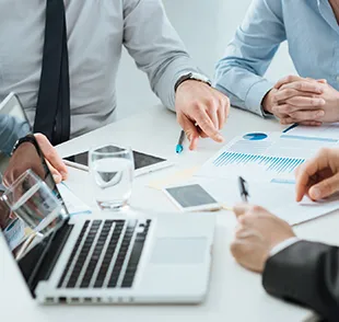 Business professionals discussing retail building permits and financial charts