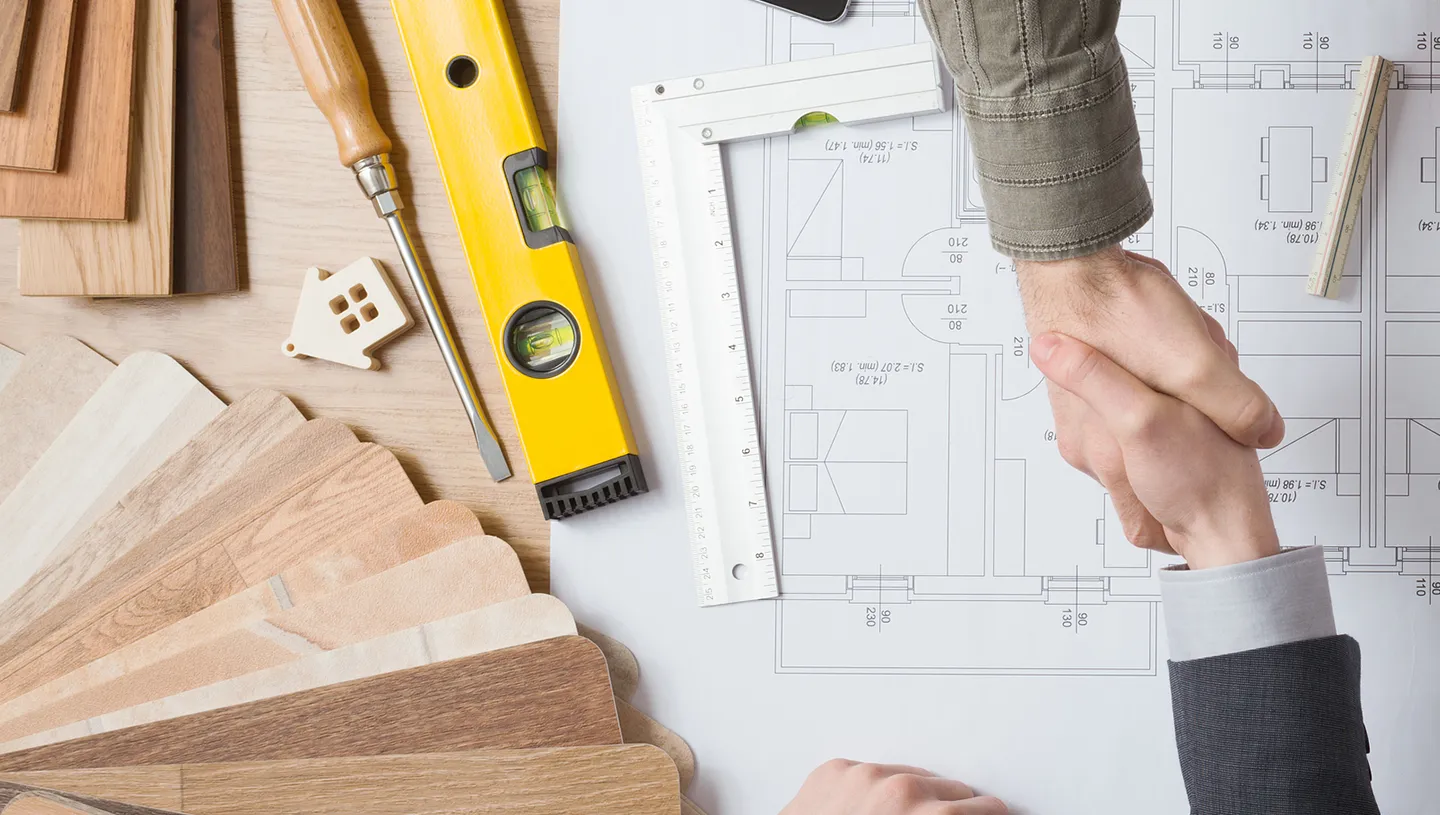 Retail building permits planning with architectural blueprints, wood samples, and tools